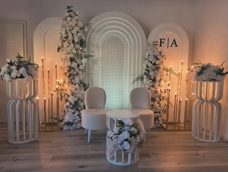 Weißer Blumenbogen mit hohen Kerzenständern am Trauungsgang